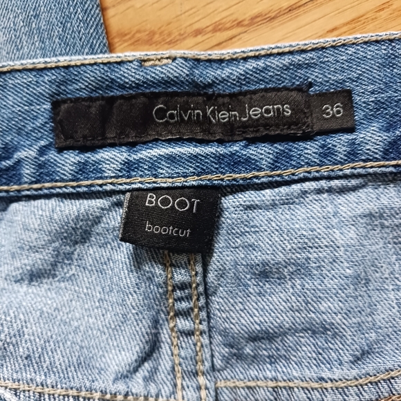 Calvin Klein • Men's Light/Medium Wash Distressed Bootcut Denim Jeans - Picture 8 of 15